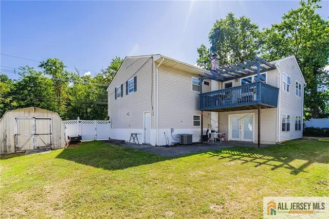 a view of a house with a yard and tree