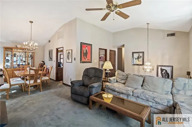 a living room with furniture and a chandelier