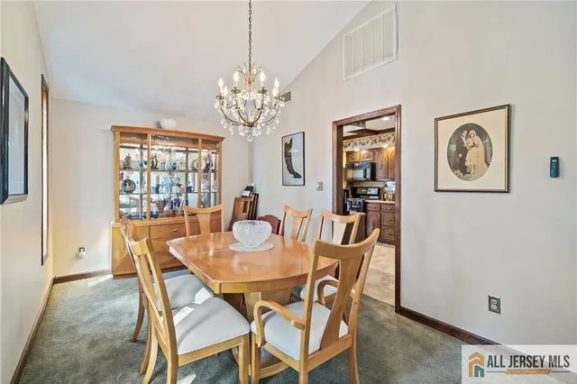 a view of a dining room with furniture and chandelier