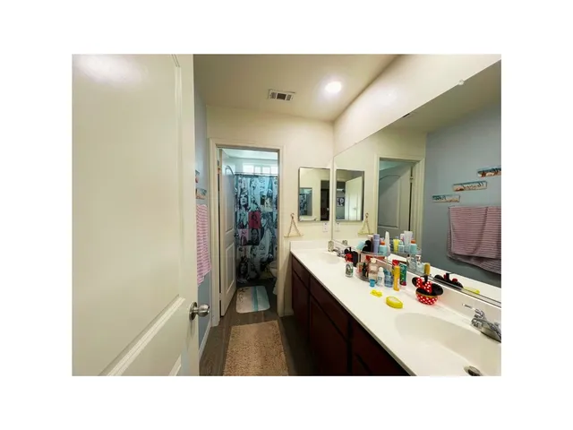 a open kitchen with stainless steel appliances kitchen island granite countertop a refrigerator a sink and dishwasher