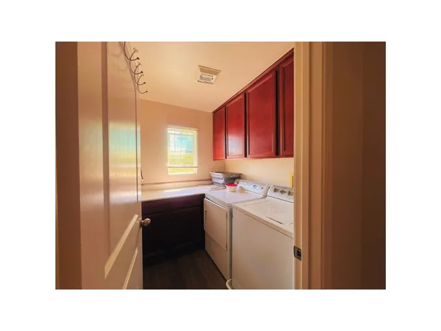 a view of an house with backyard and patio