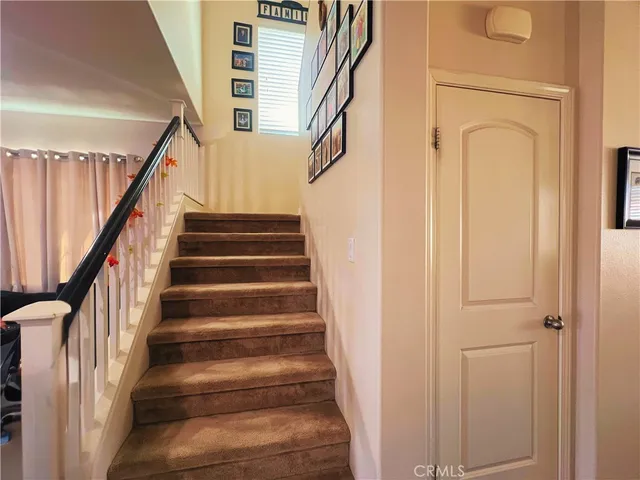 a view of staircase with wooden floor and a window