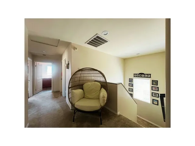 a living room with furniture a rug and white walls