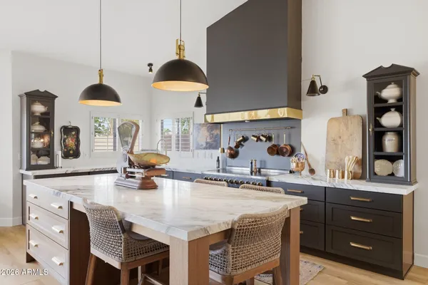 a kitchen with a table a stove and cabinets