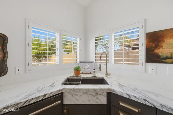 a kitchen with granite countertop a sink and a window