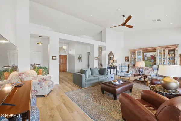 a living room with furniture and wooden floor
