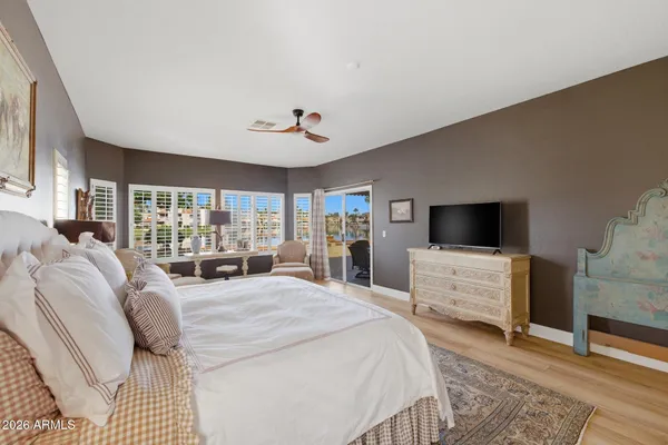 a large bedroom with a bed and large window