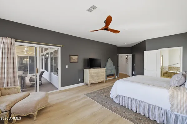 a bedroom with a large bed and a large window