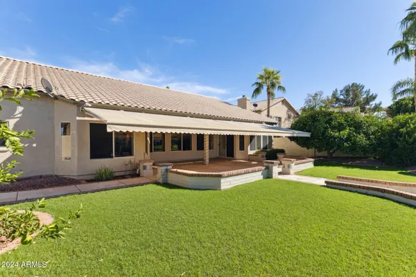 a front view of house with a garden and patio