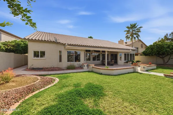 a view of a house with a swimming pool and a yard
