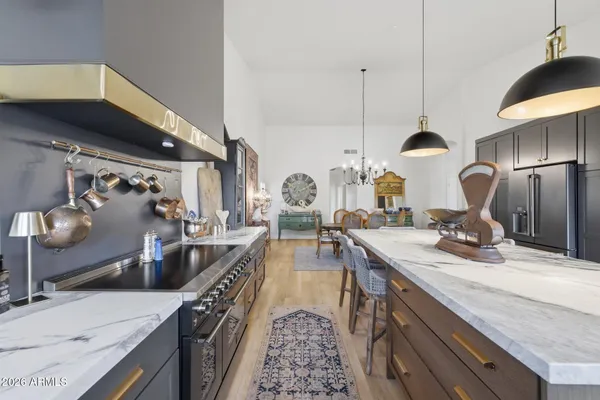 a kitchen with counter top a sink a stove and refrigerator