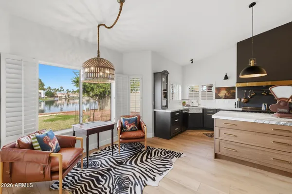a living room with furniture a rug and a chandelier
