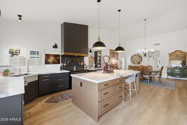 a kitchen with stainless steel appliances granite countertop a stove and a sink