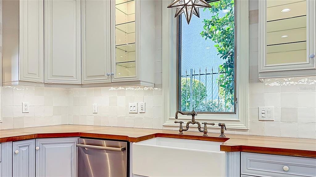 660 Osceola Avenue, Unit 101 Winter Park, FL 32789 - Photo 14 of 65 a kitchen with stainless steel appliances granite countertop a sink and a window