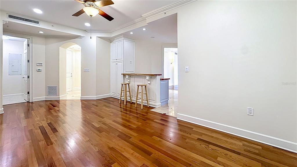 660 Osceola Avenue, Unit 101 Winter Park, FL 32789 - Photo 21 of 65 a view of an empty room with wooden floor and a ceiling fan