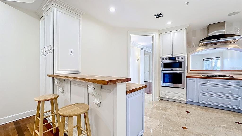 660 Osceola Avenue, Unit 101 Winter Park, FL 32789 - Photo 22 of 65 a kitchen with granite countertop a refrigerator and stove