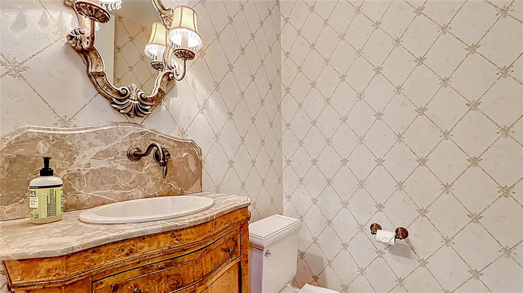660 Osceola Avenue, Unit 101 Winter Park, FL 32789 - Photo 23 of 65 a bathroom with a granite countertop sink and a mirror