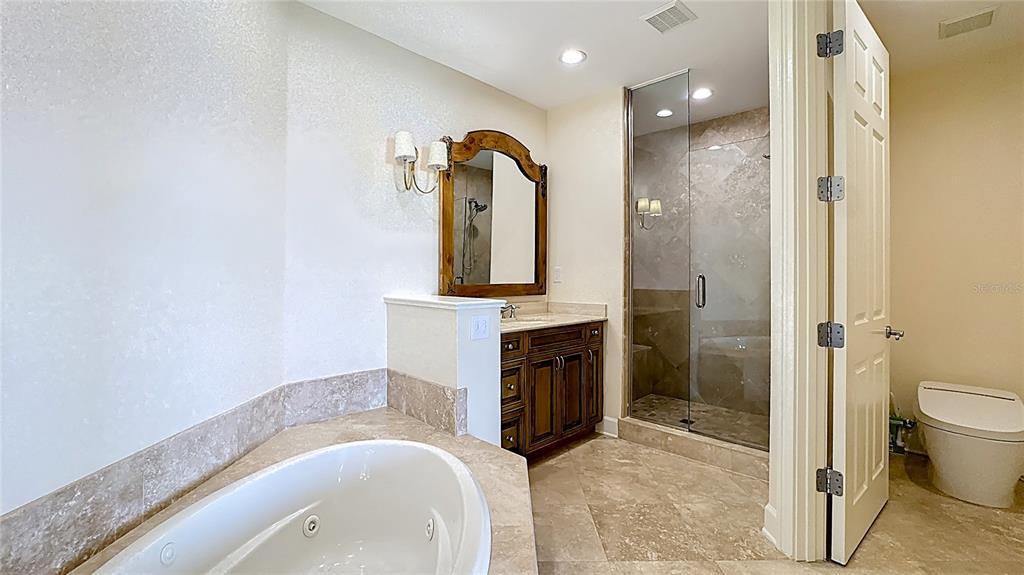 660 Osceola Avenue, Unit 101 Winter Park, FL 32789 - Photo 31 of 65 a spacious bathroom with a granite countertop sink a toilet and shower