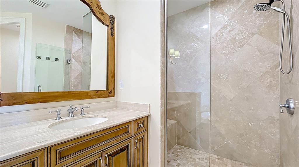 660 Osceola Avenue, Unit 101 Winter Park, FL 32789 - Photo 32 of 65 a bathroom with a granite countertop sink a mirror and shower