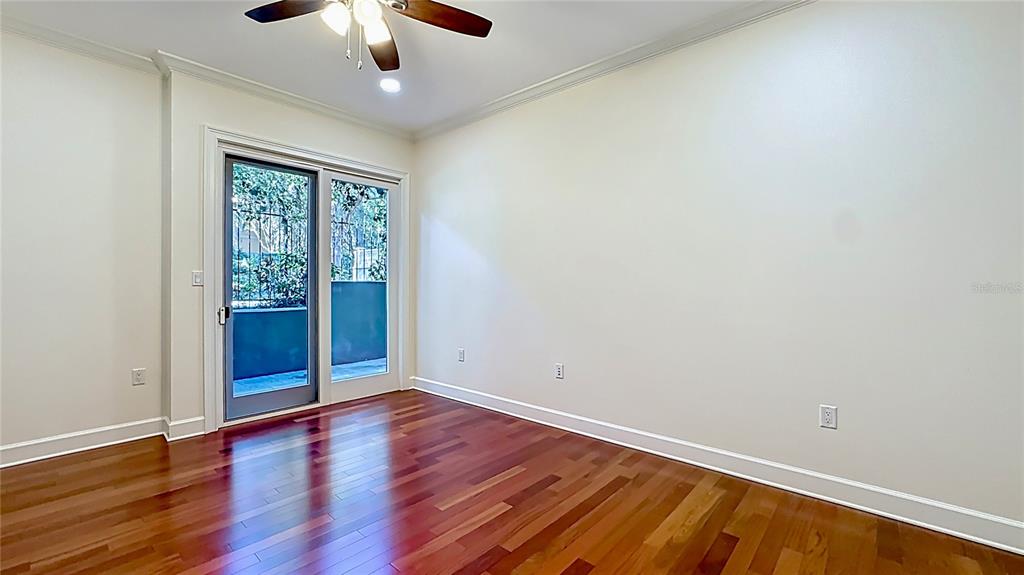 660 Osceola Avenue, Unit 101 Winter Park, FL 32789 - Photo 41 of 65 an empty room with wooden floor chandelier fan and windows