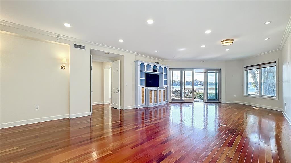 660 Osceola Avenue, Unit 101 Winter Park, FL 32789 - Photo 5 of 65 a view of empty room with wooden floor and floor to ceiling window