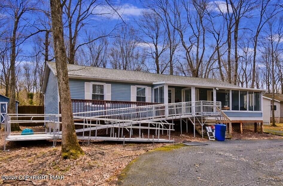 201 Buckhill Road Albrightsville, PA 18210 - Photo 1 of 32 a view of a house with a large window and wooden fence