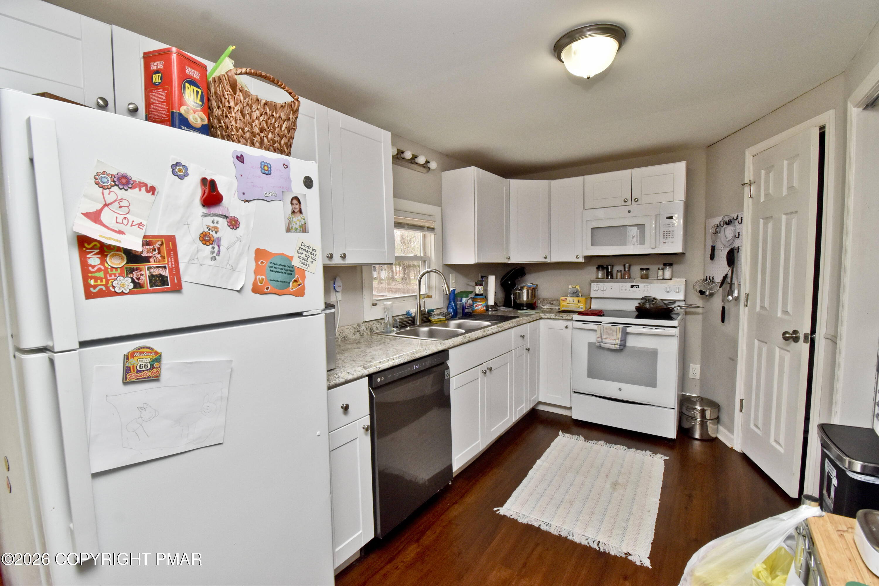201 Buckhill Road Albrightsville, PA 18210 - Photo 7 of 32 a kitchen with white cabinets and white appliances