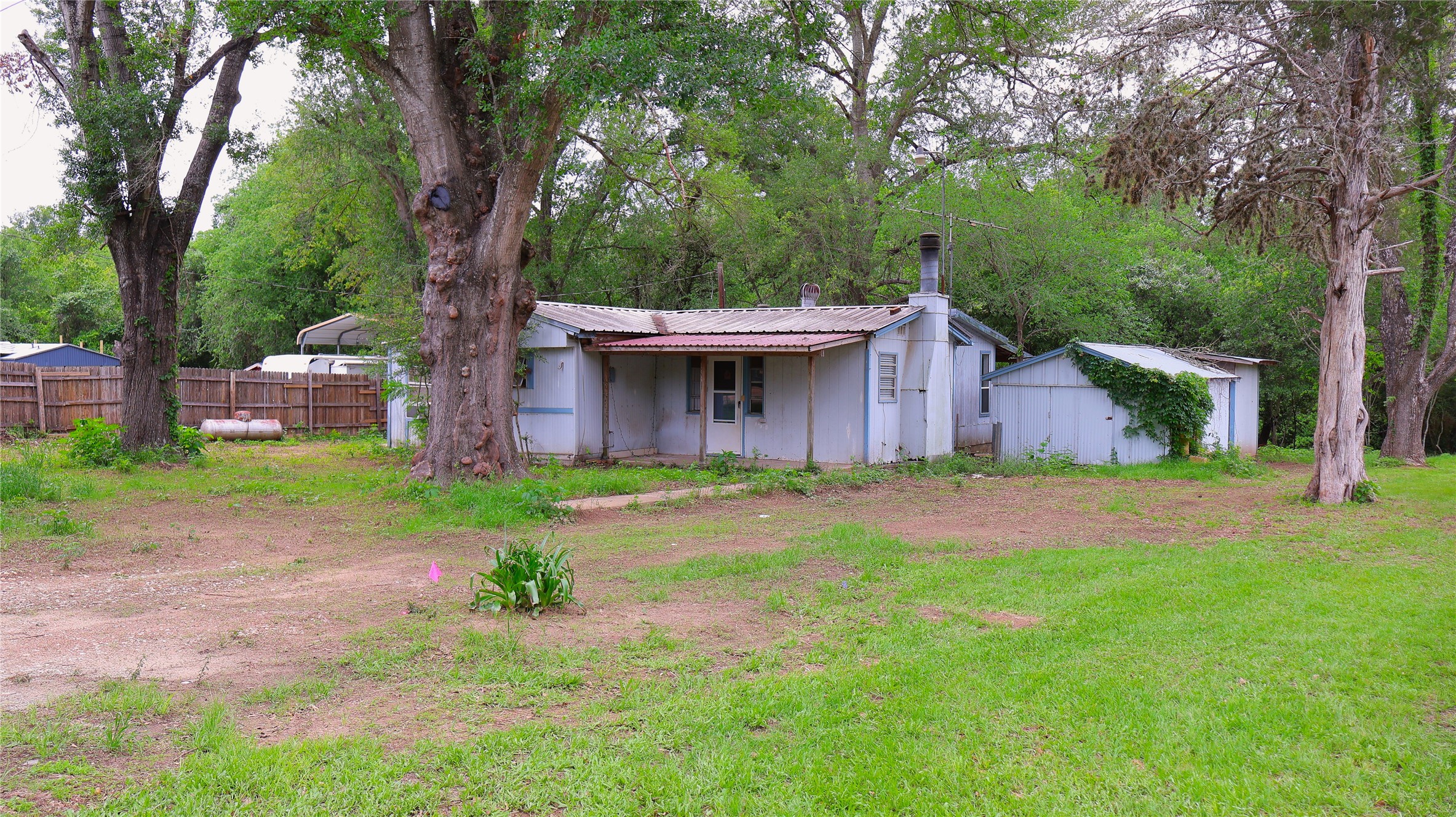 175 Ash St, Bastrop. Land is offered for sale. Home conveys at no extra cost.