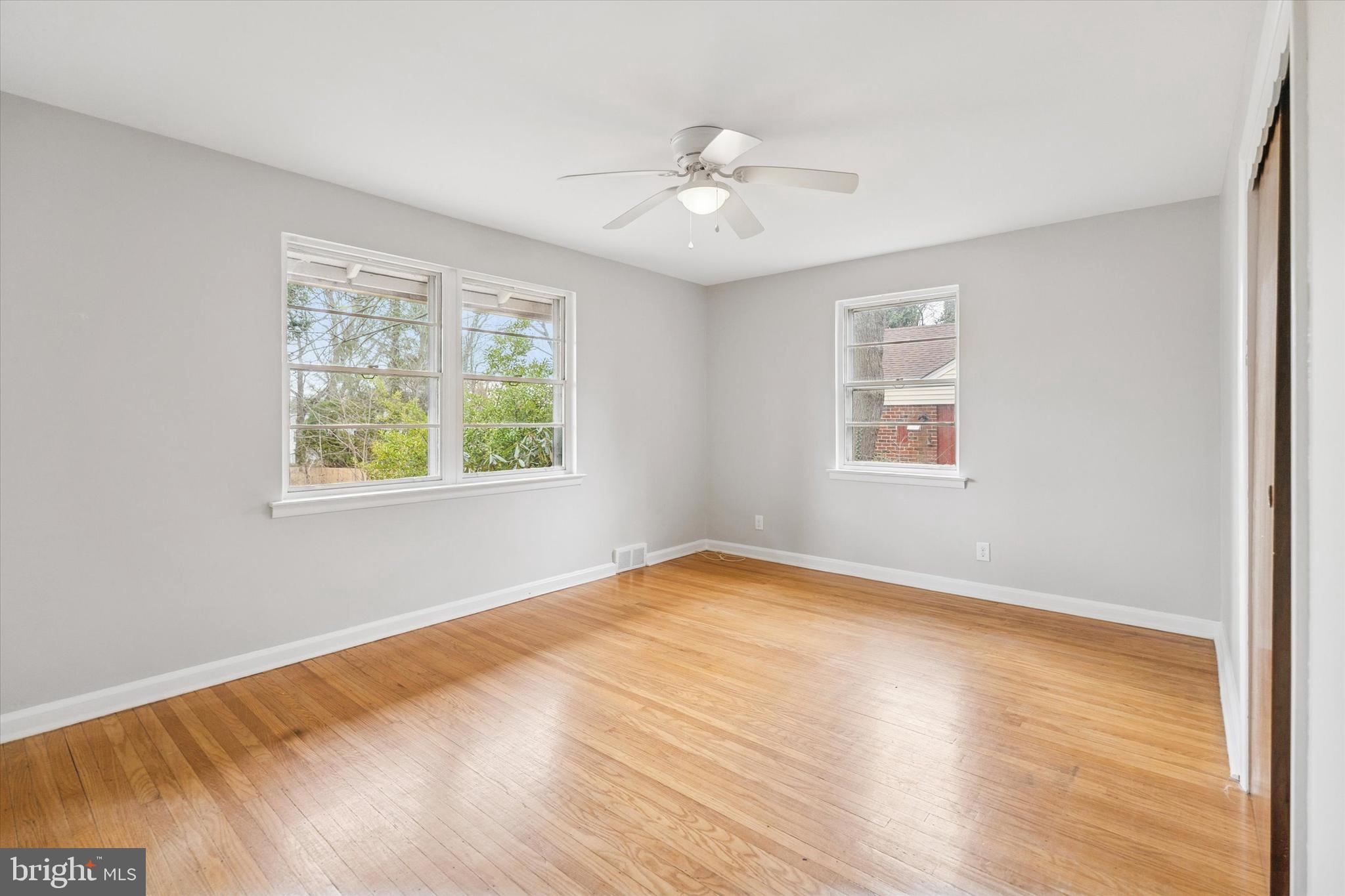 211 Kent Road Wyncote, PA 19095 - Photo 13 of 26 a view of an empty room with wooden floor and a window
