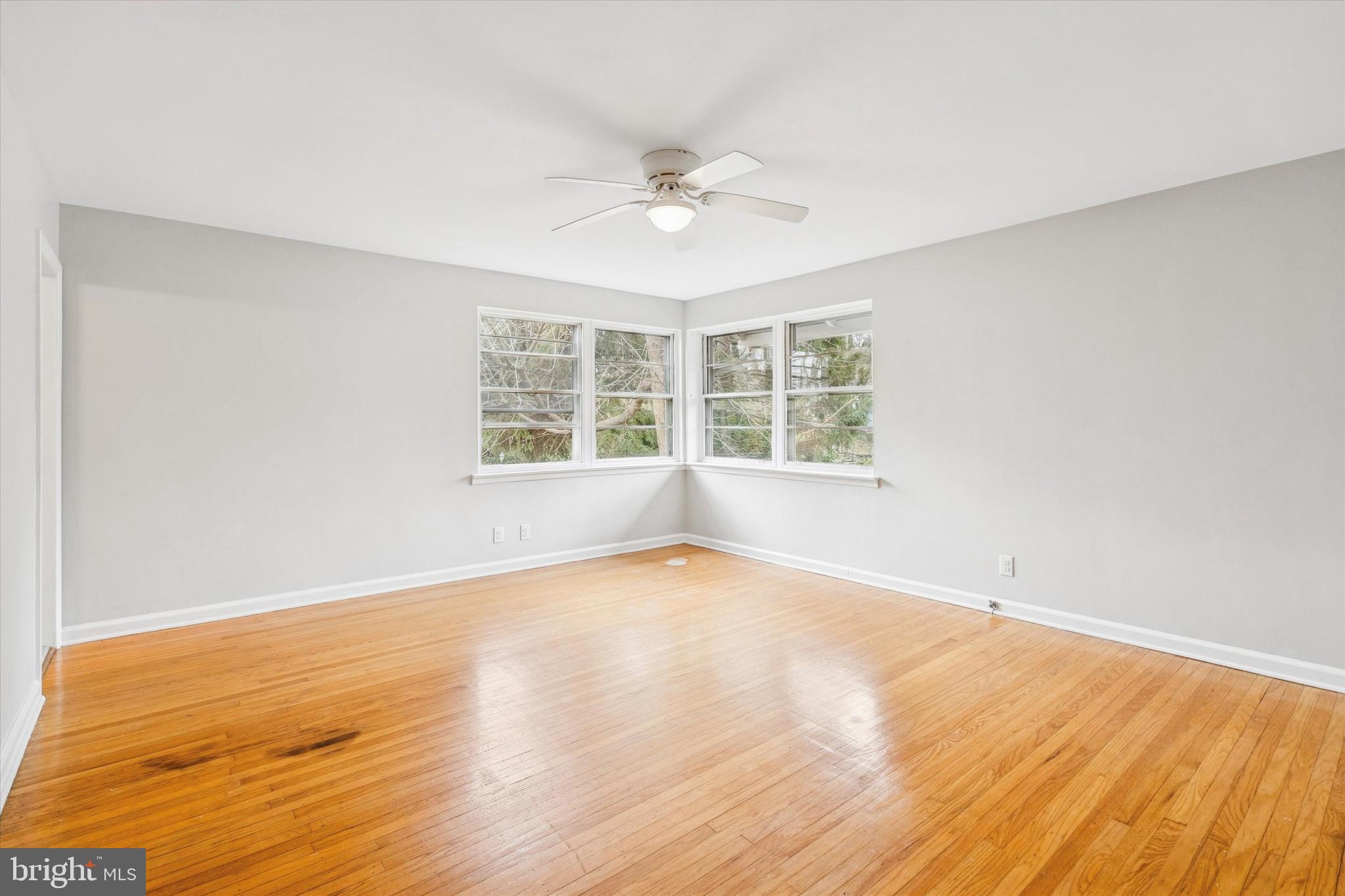 211 Kent Road Wyncote, PA 19095 - Photo 16 of 26 an empty room with wooden floor and windows
