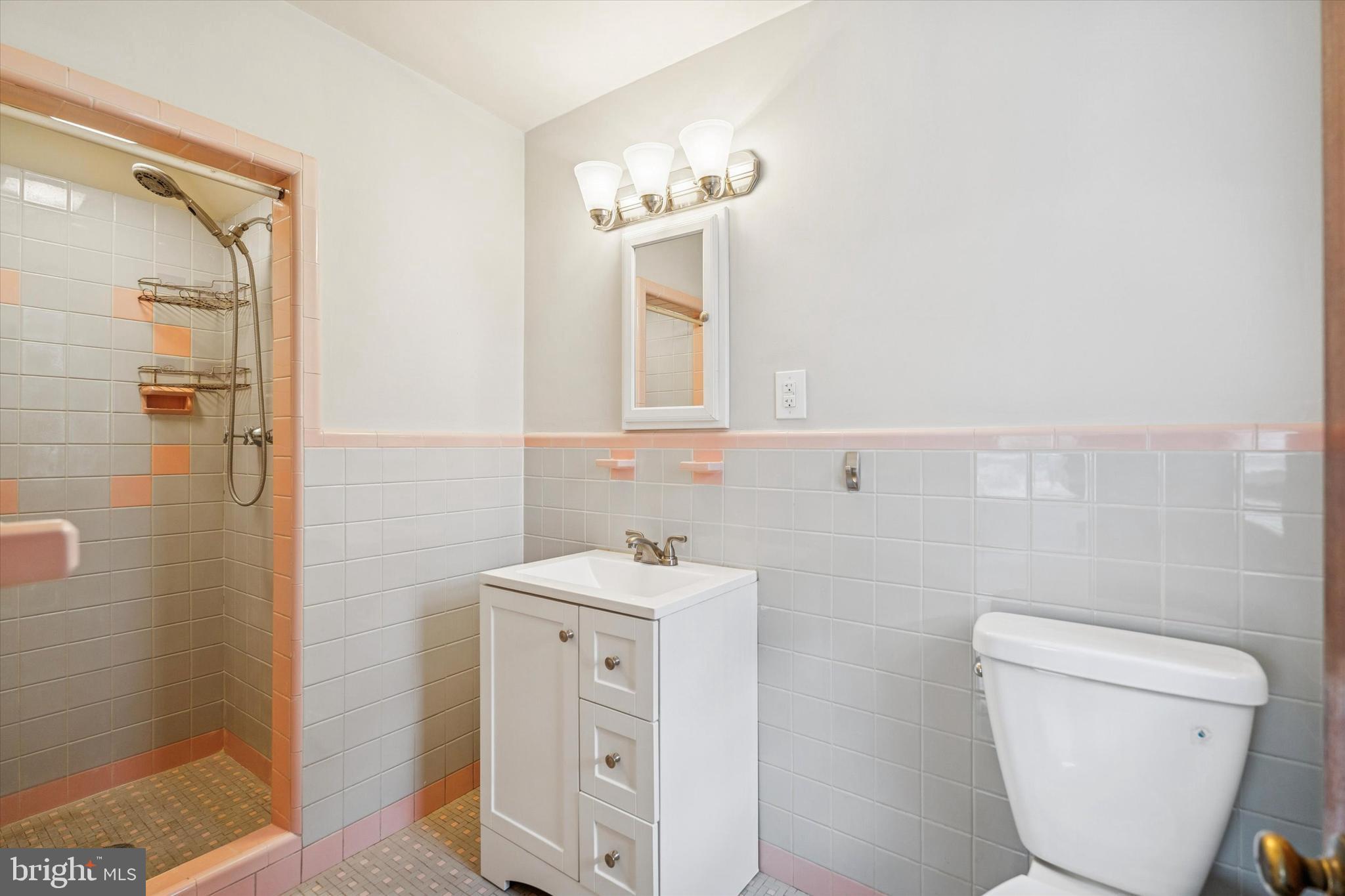 211 Kent Road Wyncote, PA 19095 - Photo 18 of 26 a bathroom with a toilet sink and mirror
