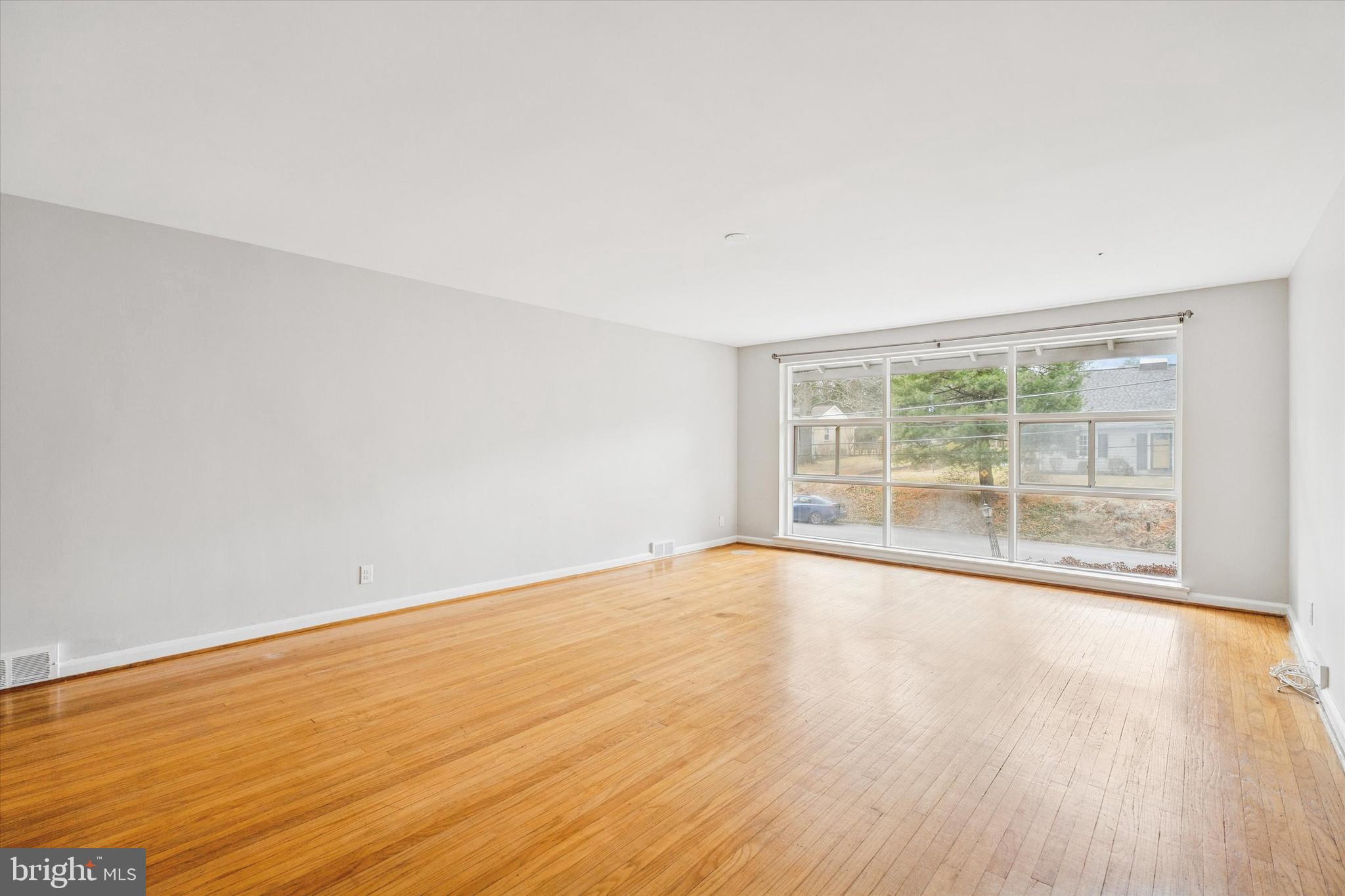 211 Kent Road Wyncote, PA 19095 - Photo 2 of 26 wooden floor in an empty room with a window