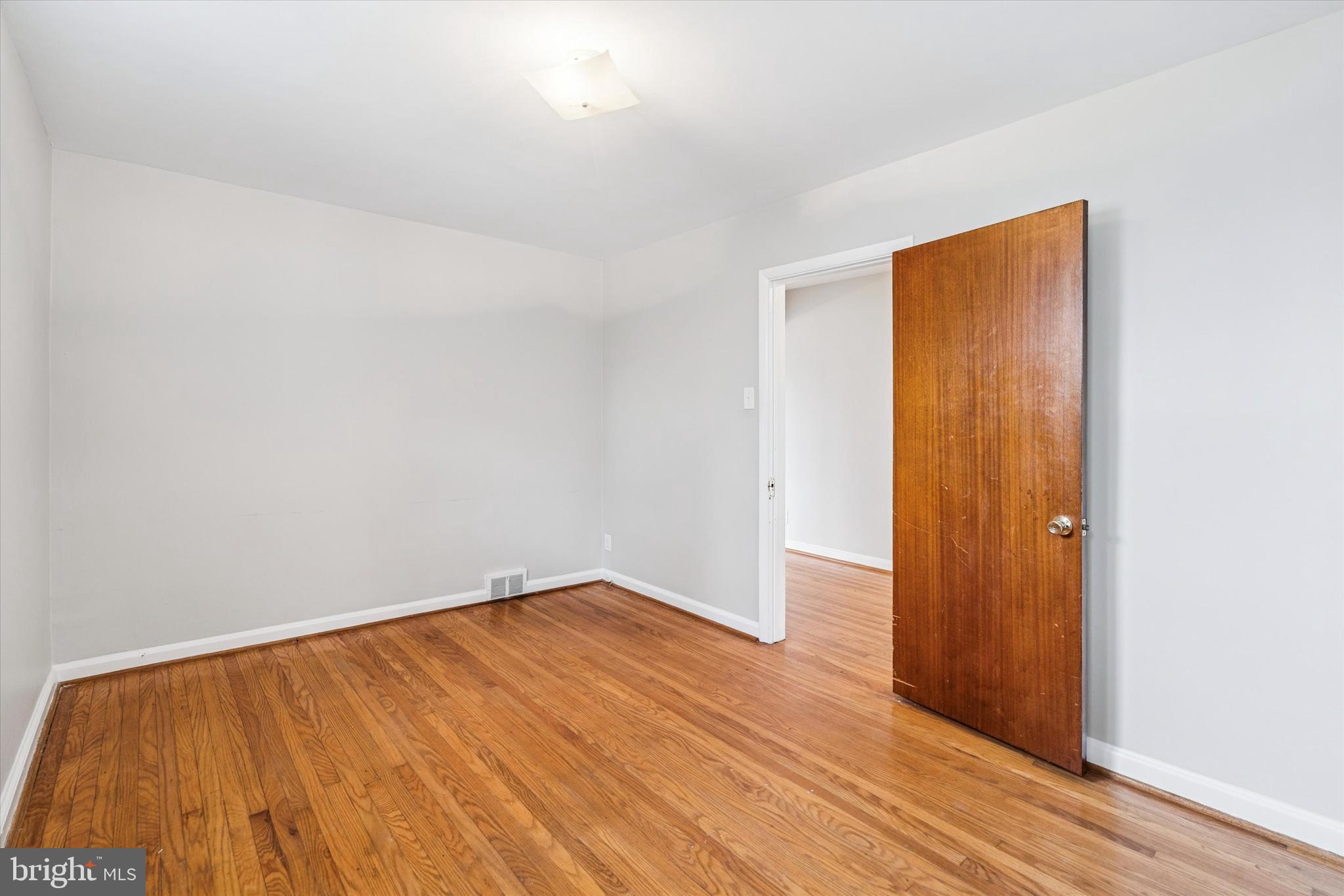211 Kent Road Wyncote, PA 19095 - Photo 5 of 26 an empty room with wooden floor and closet