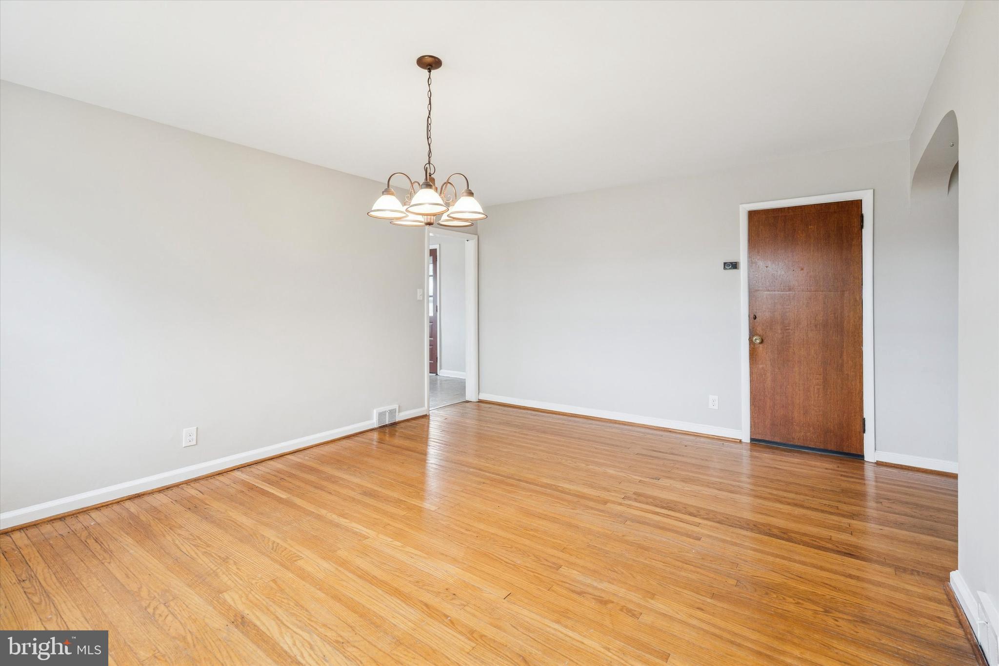 211 Kent Road Wyncote, PA 19095 - Photo 6 of 26 a view of an empty room with wooden floor and a window