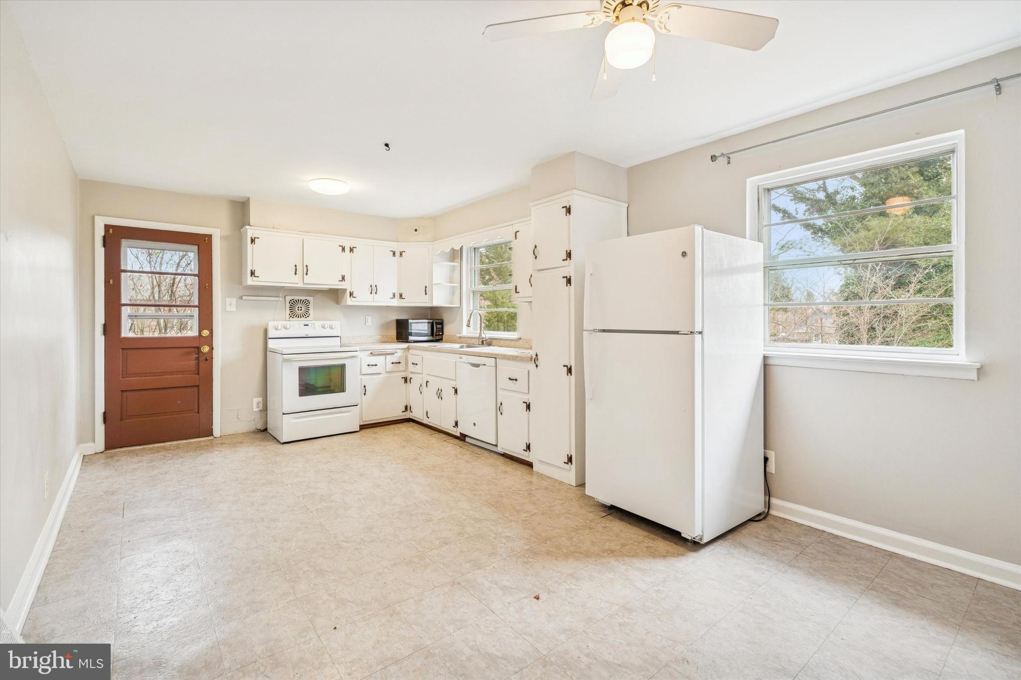 211 Kent Road Wyncote, PA 19095 - Photo 8 of 26 a kitchen with white cabinets and white appliances