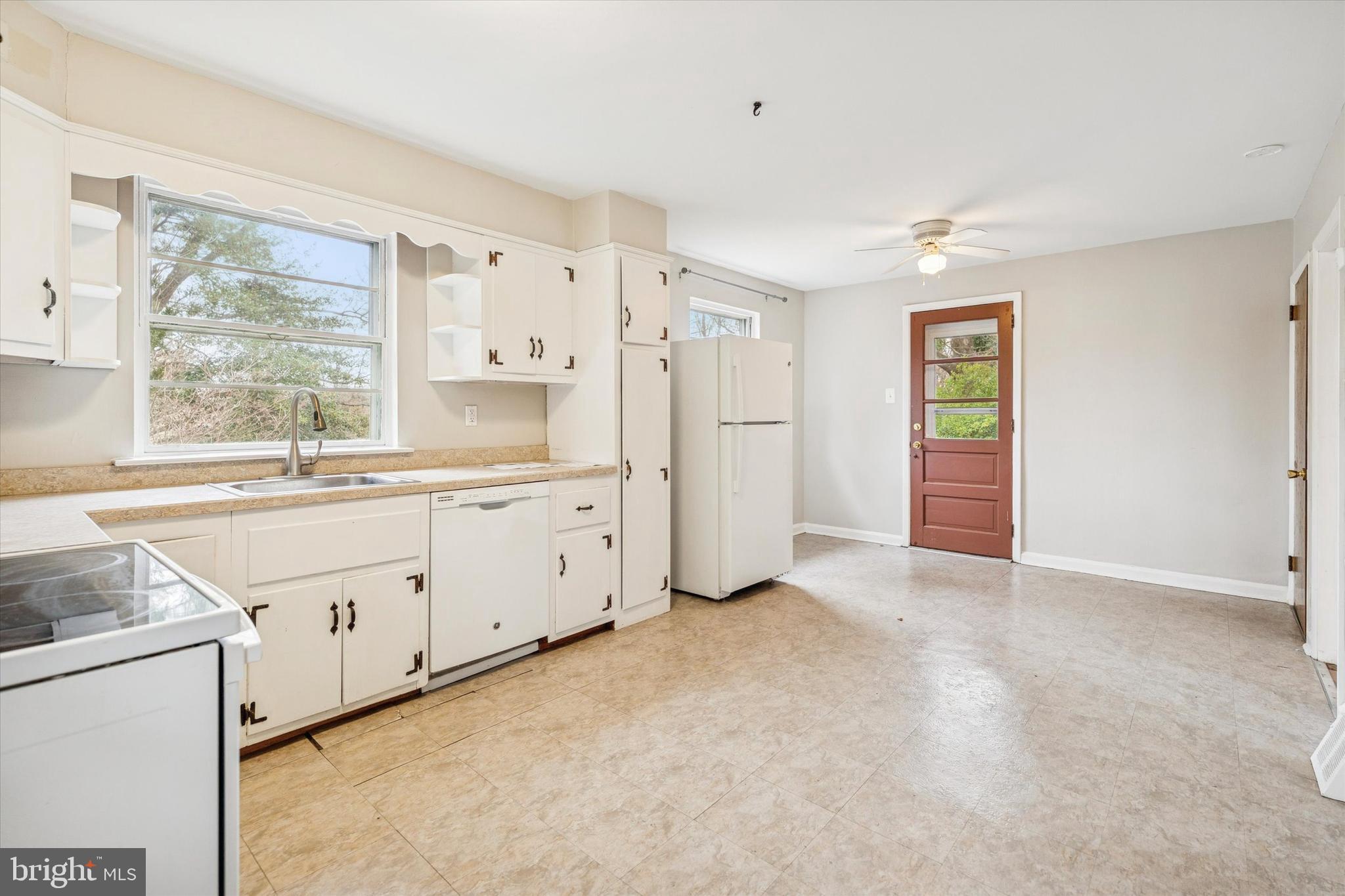 211 Kent Road Wyncote, PA 19095 - Photo 9 of 26 a large white kitchen with a stove a sink dishwasher and a refrigerator