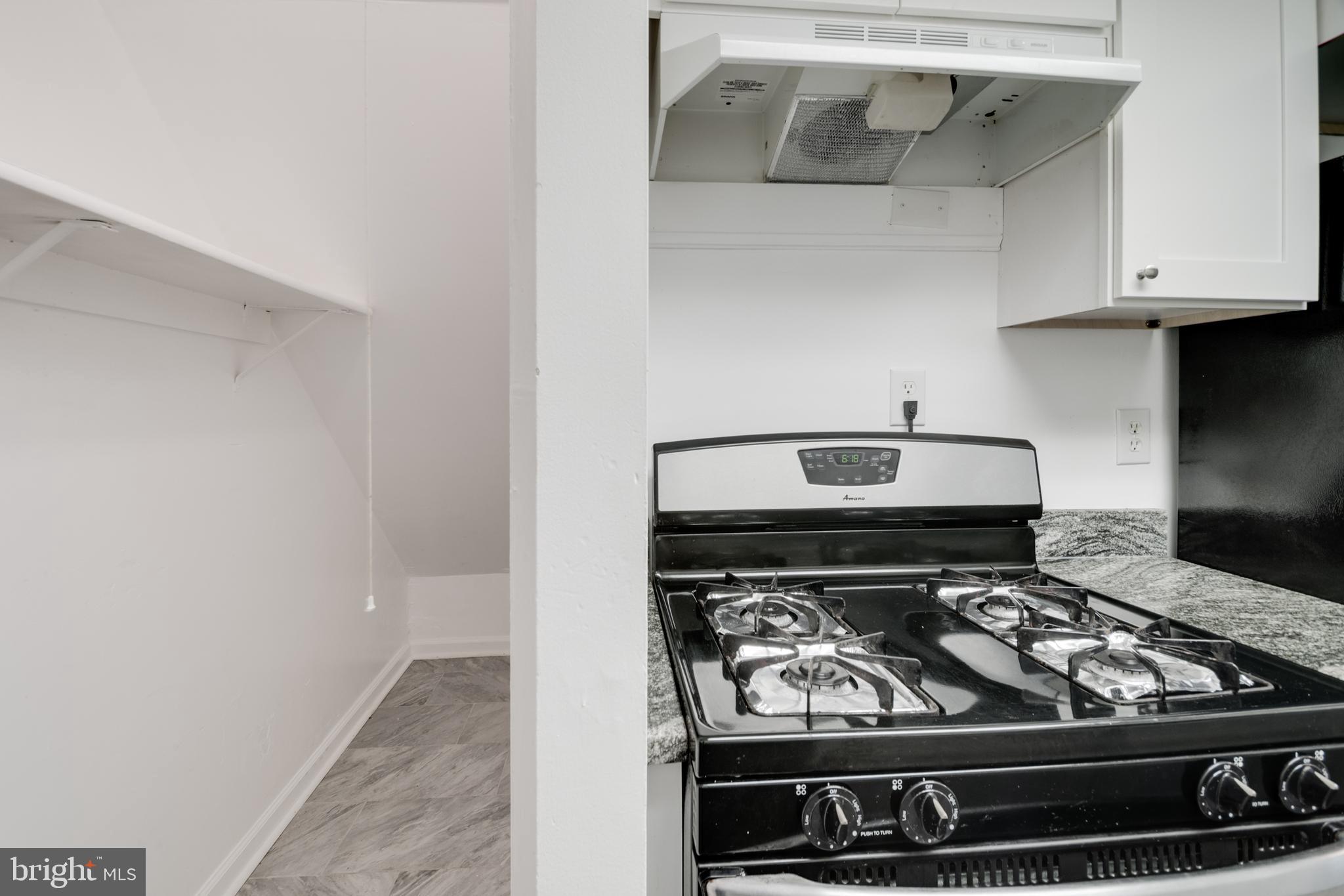 76 King Henry Circle, Unit 76B Baltimore, MD 21237 - Photo 13 of 29 a stove top oven sitting inside of a kitchen