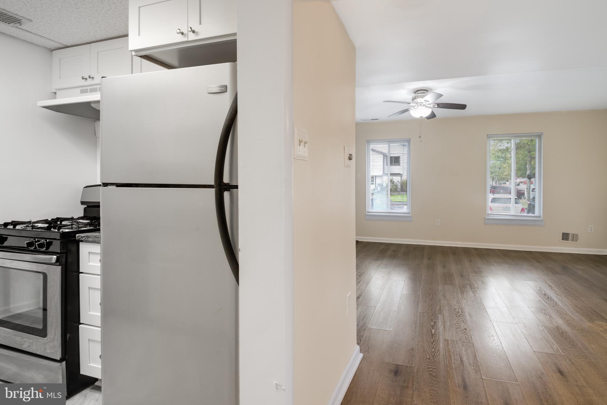 76 King Henry Circle, Unit 76B Baltimore, MD 21237 - Photo 18 of 29 a view of a kitchen with refrigerator and wooden floor
