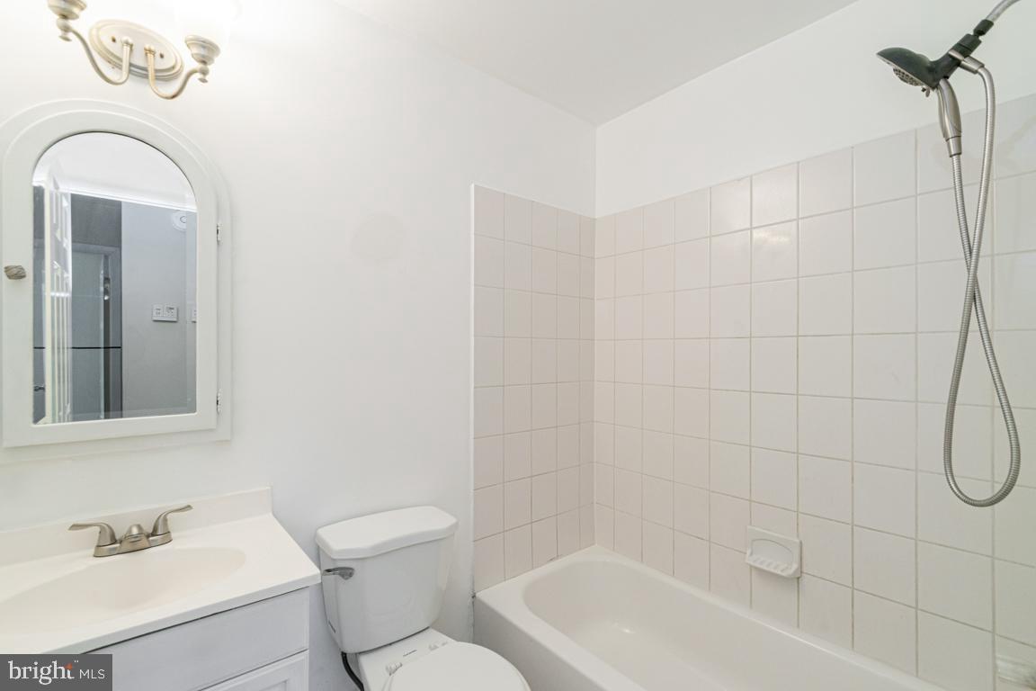 76 King Henry Circle, Unit 76B Baltimore, MD 21237 - Photo 22 of 29 a bathroom with a sink a toilet and shower