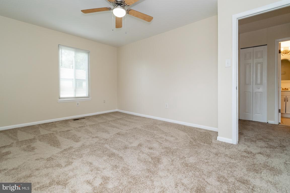 76 King Henry Circle, Unit 76B Baltimore, MD 21237 - Photo 24 of 29 an empty room with windows and fan