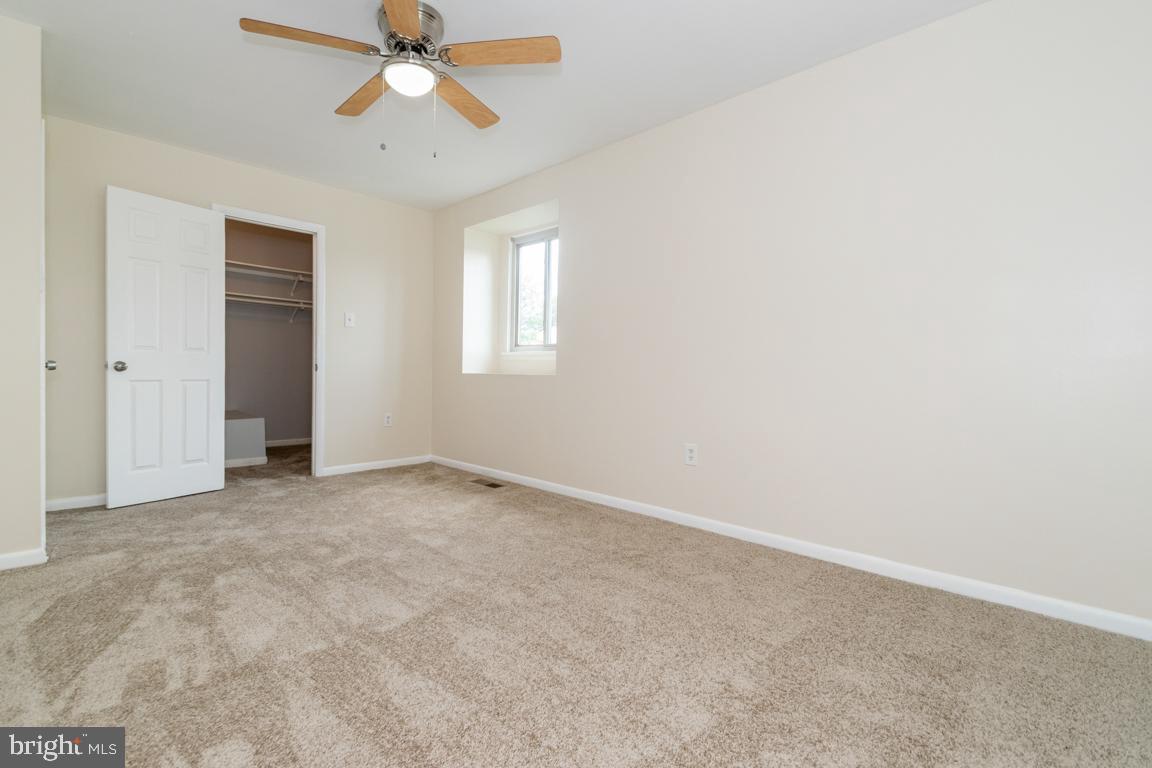 76 King Henry Circle, Unit 76B Baltimore, MD 21237 - Photo 26 of 29 an empty room with windows and fan