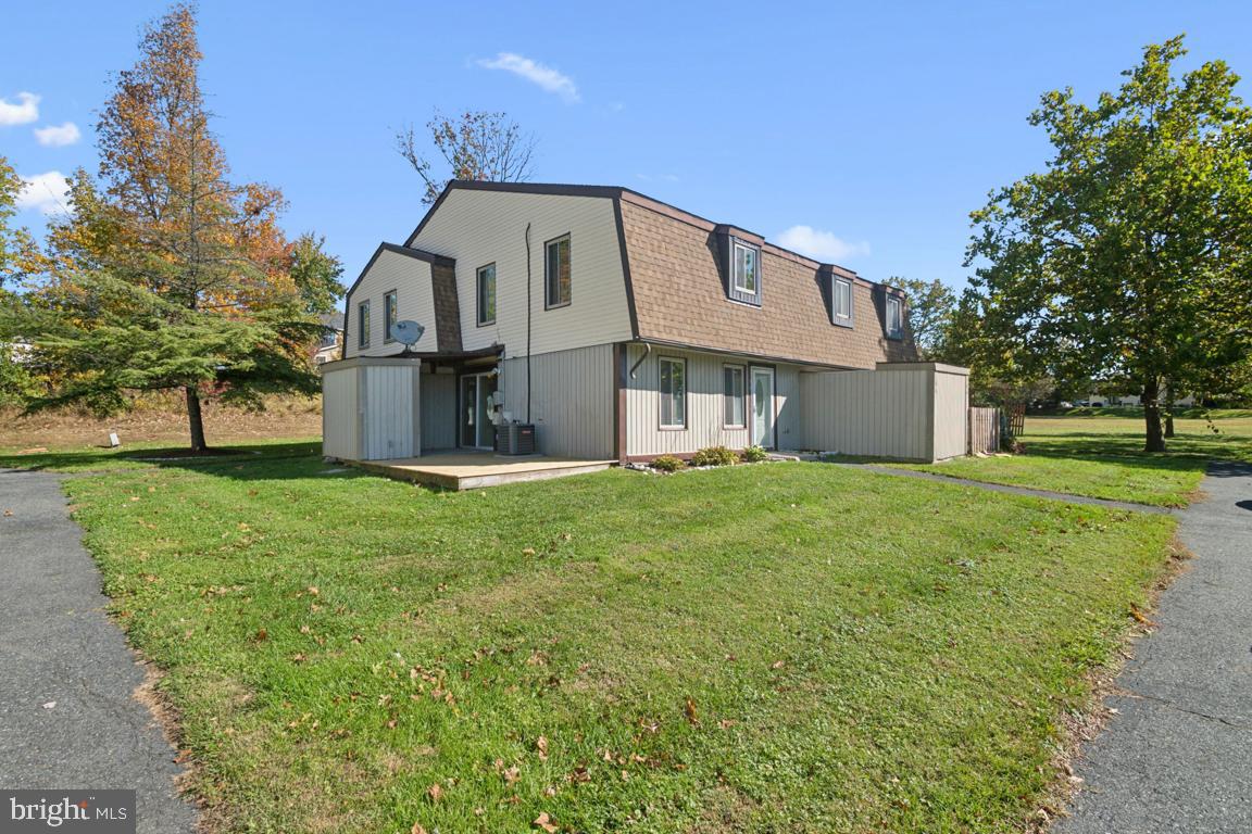 76 King Henry Circle, Unit 76B Baltimore, MD 21237 - Photo 29 of 29 a front view of a house with a yard