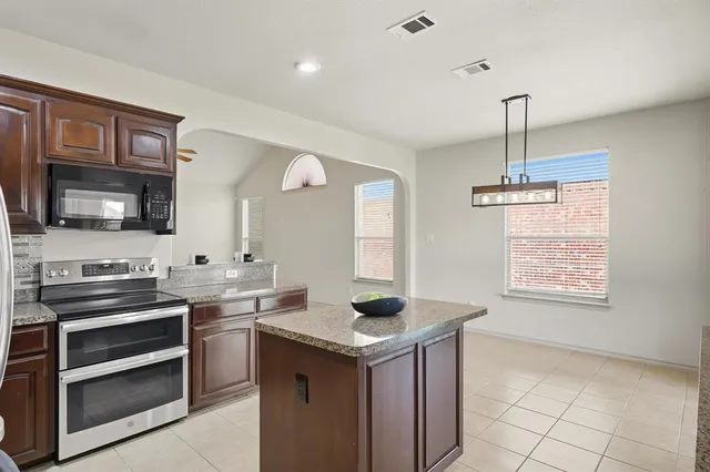 a kitchen that has a sink cabinets appliances and a window