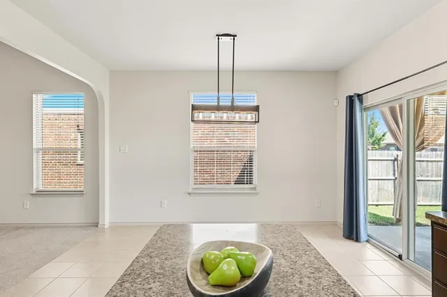 a view of an empty room with window and cabinet