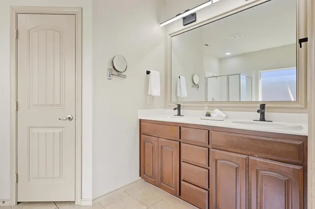 a bathroom with a double vanity sink and a mirror