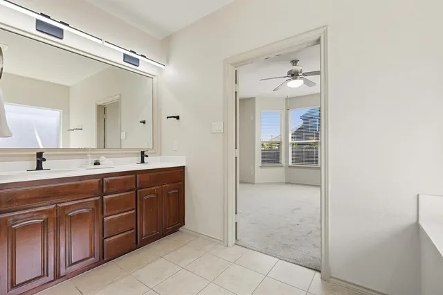 a spacious bathroom with a double vanity sink shower and a mirror