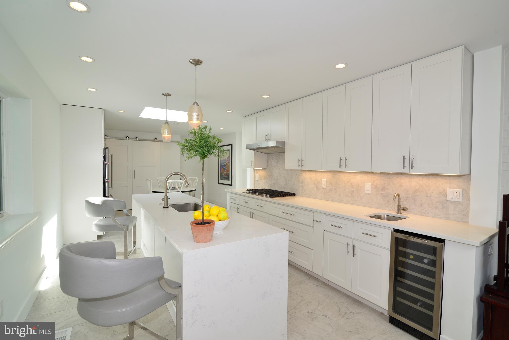 11316 South Shore Road Reston, VA 20190 - Photo 10 of 29 a kitchen with a sink white cabinets and stove