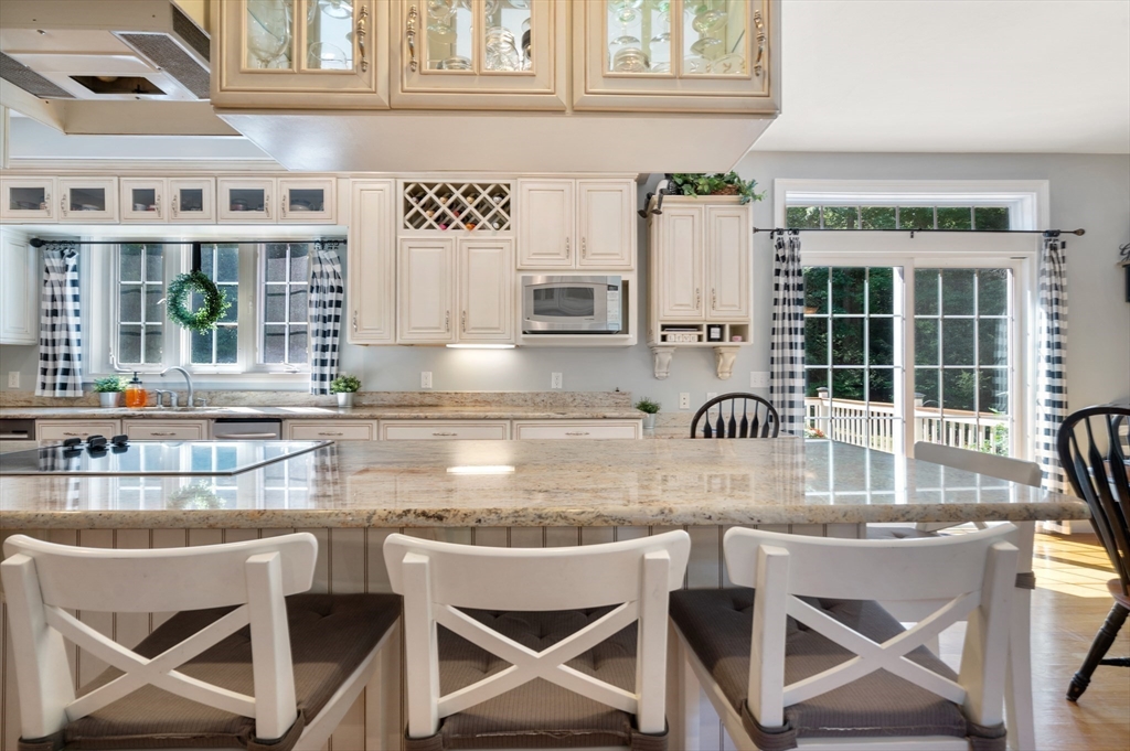 400 New Boston Road Sturbridge, MA 01566 - Photo 17 of 42 a kitchen with a dining table chairs and refrigerator