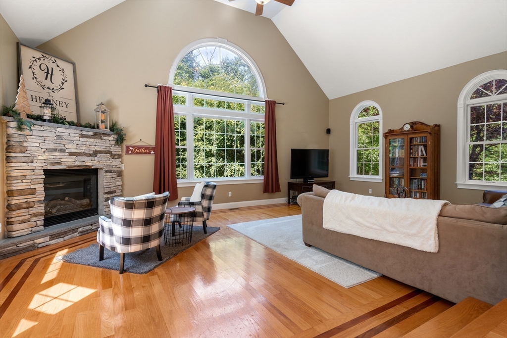 400 New Boston Road Sturbridge, MA 01566 - Photo 19 of 42 a living room with furniture a large window and a fireplace