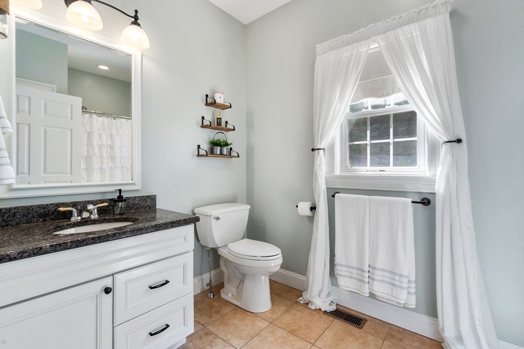 400 New Boston Road Sturbridge, MA 01566 - Photo 25 of 42 a bathroom with a granite countertop sink toilet and mirror